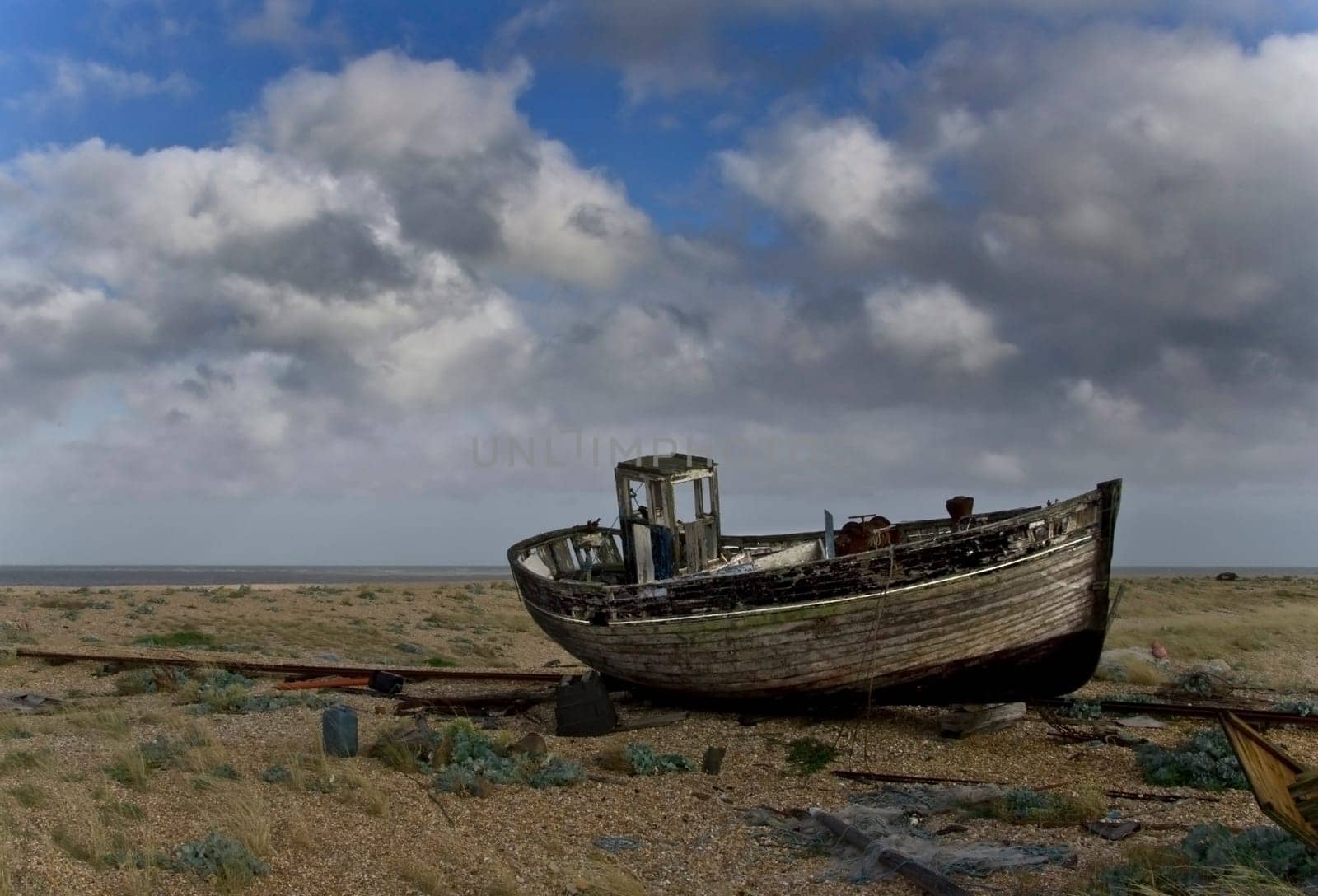Broken down old fishing boat marooned on a beach