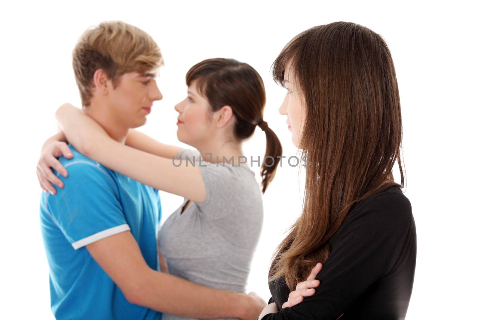 Sad brunette girl jealousy about her friend. Isolated on white background.