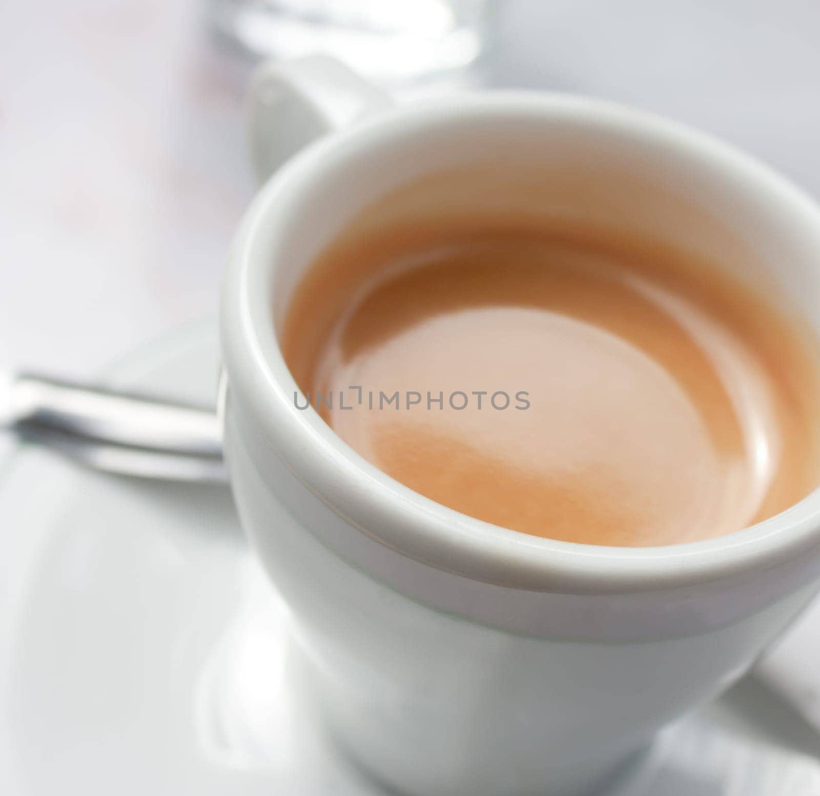 Close-up view of a white cup of coffee, espresso
