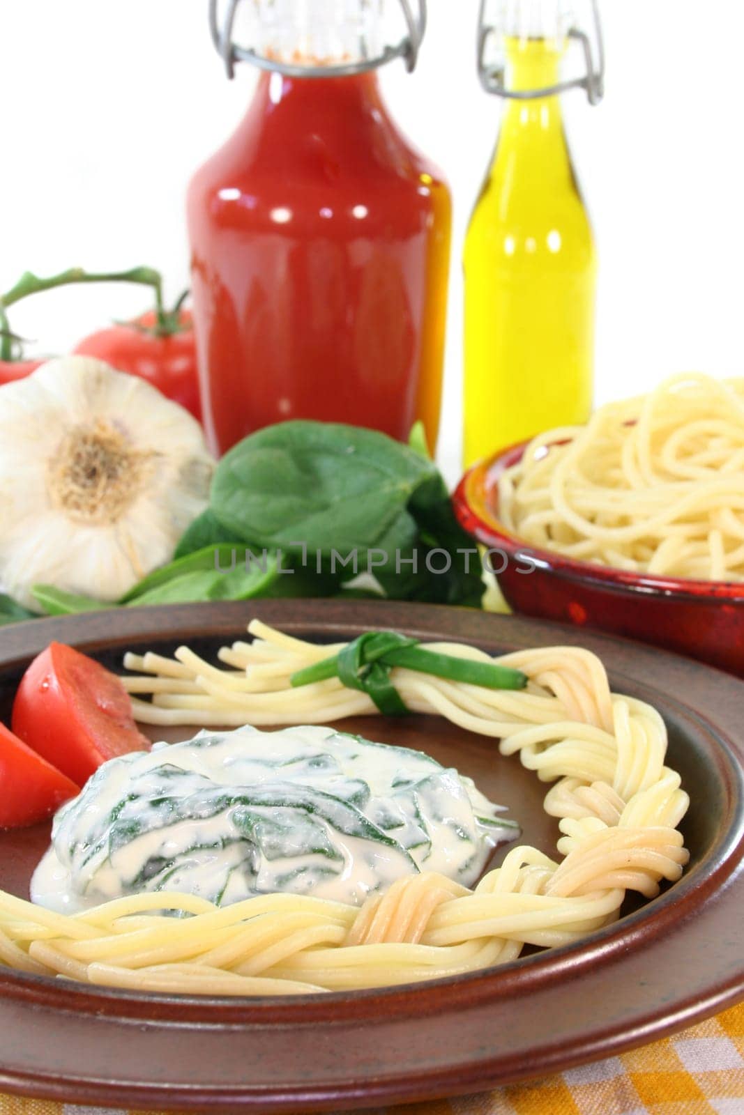 a plaited pasta with spinach cheese sauce with fresh ingredients