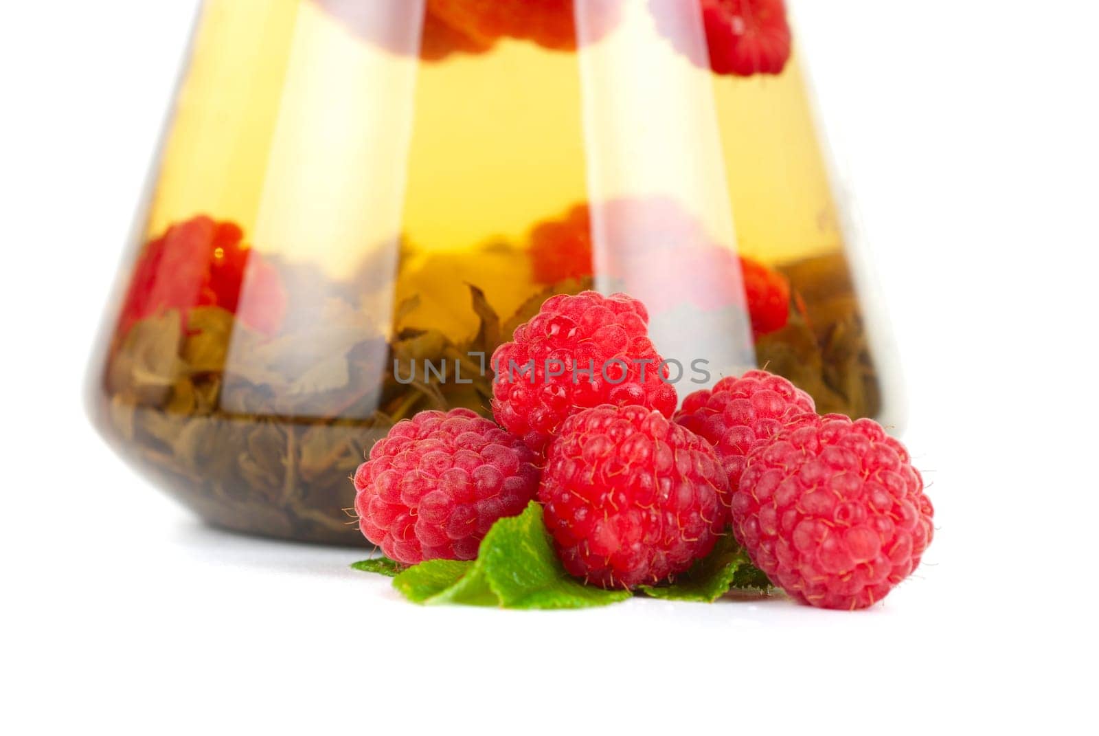 Teapot with fruit tea and berries on a white background
