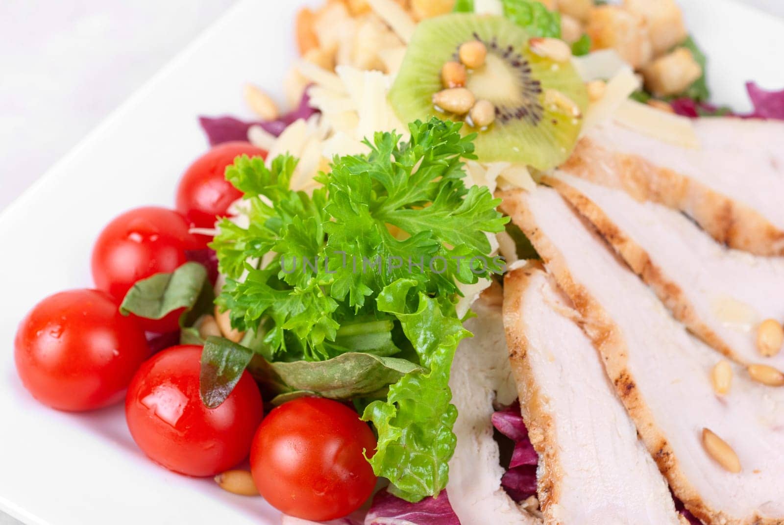 Tasty appetizer of meat, cherry tomato, greens and groundnut
