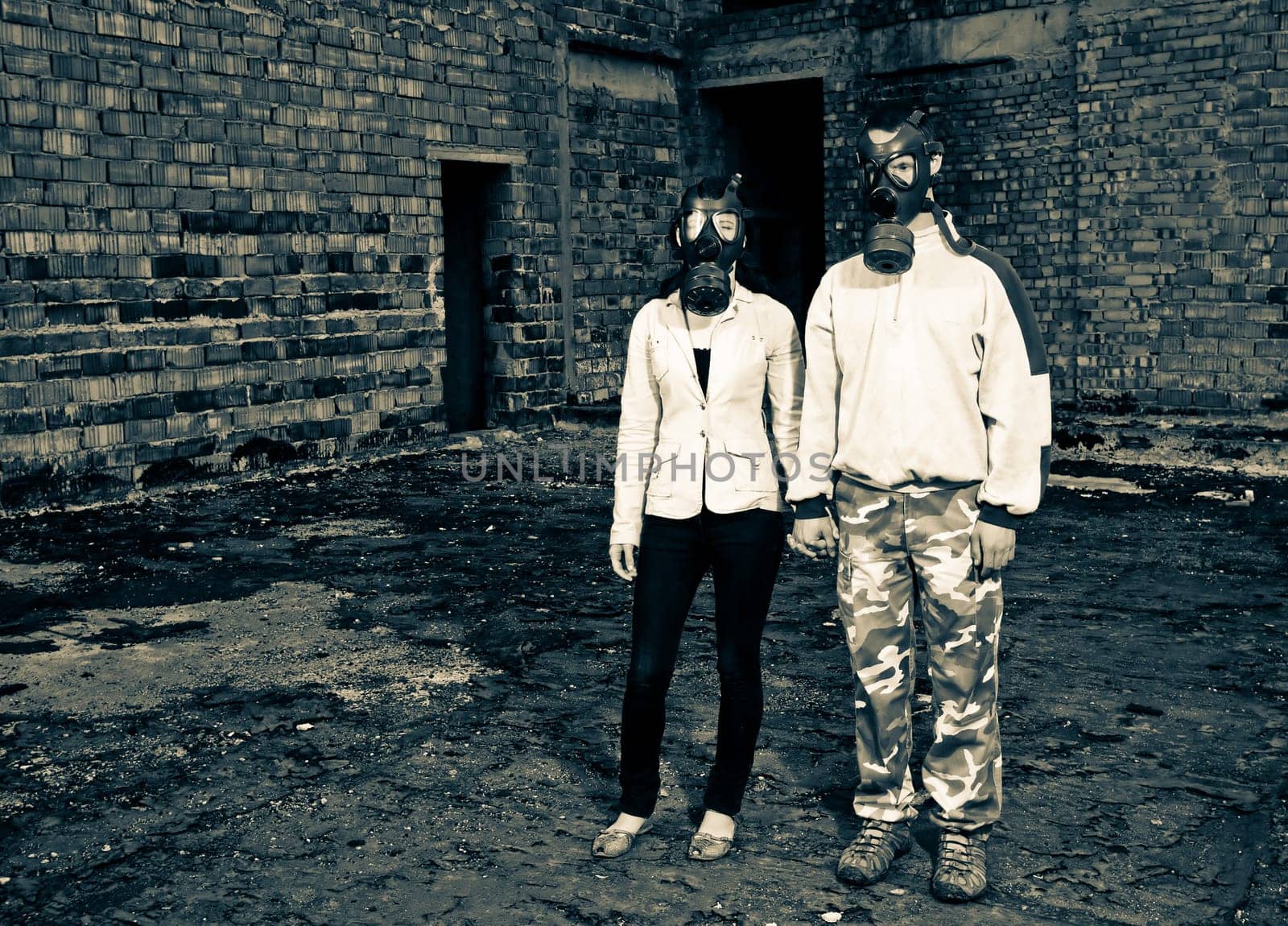Bizarre portrait of romantic couple with gas masks