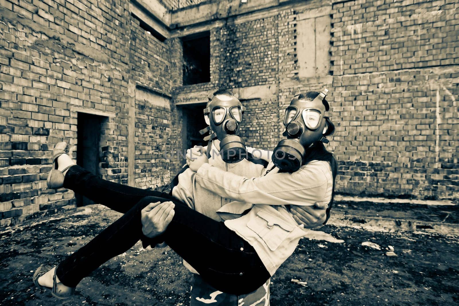 Bizarre portrait of romantic couple with gas masks