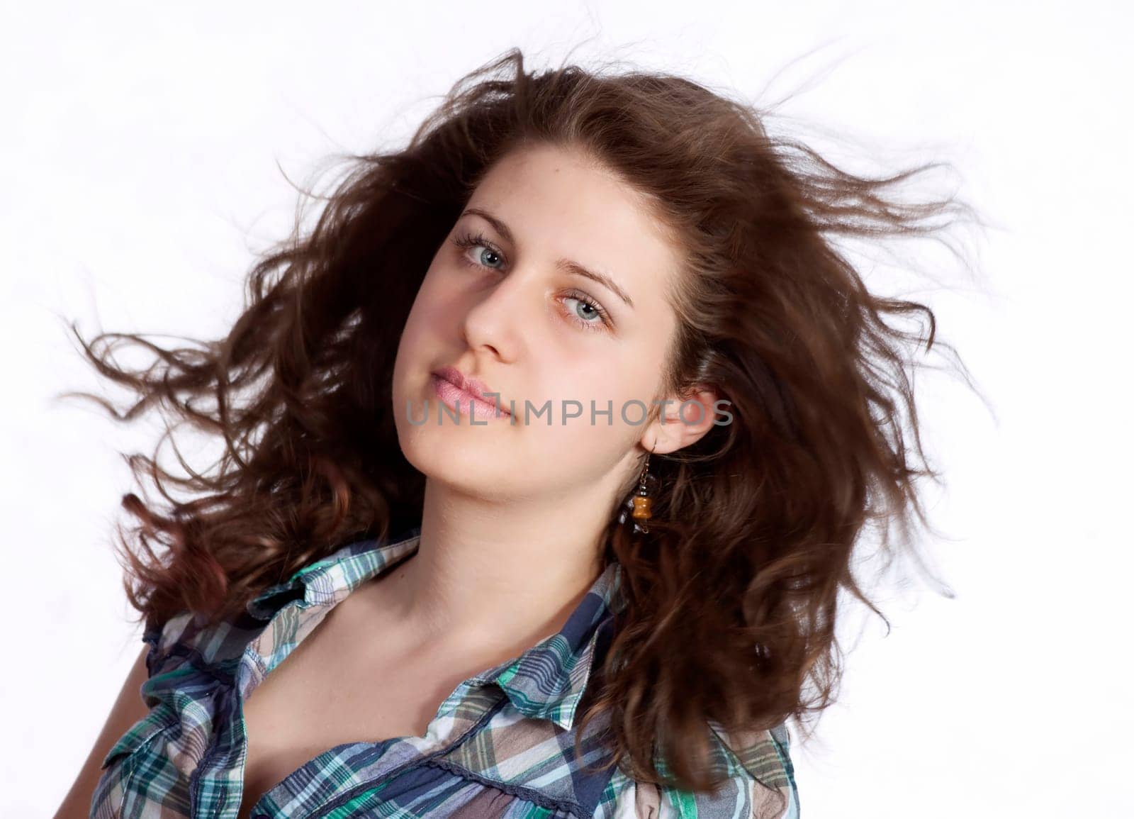 young brunette woman with long flying hair, studio shot