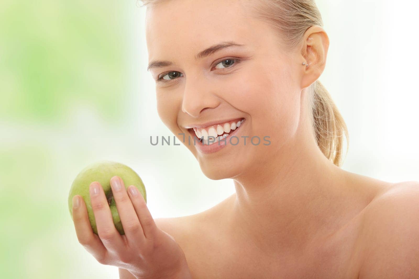 Beautiful girl eating green apple