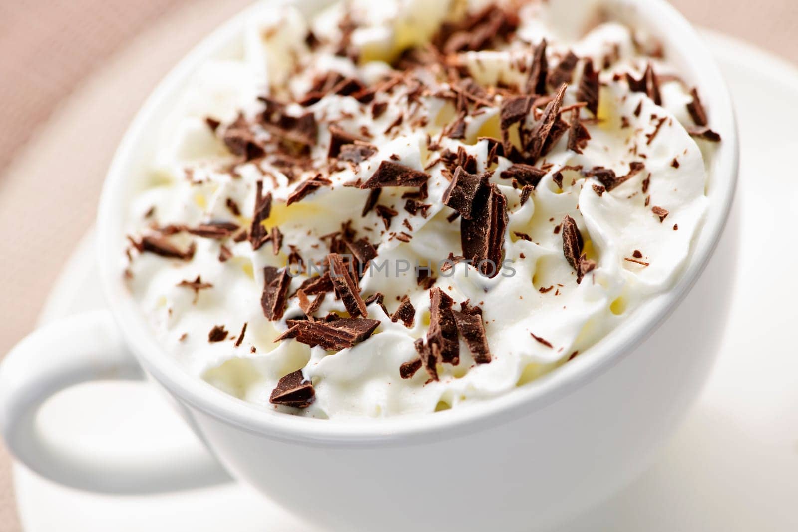 Hot cocoa with shaved chocolate and whipped cream