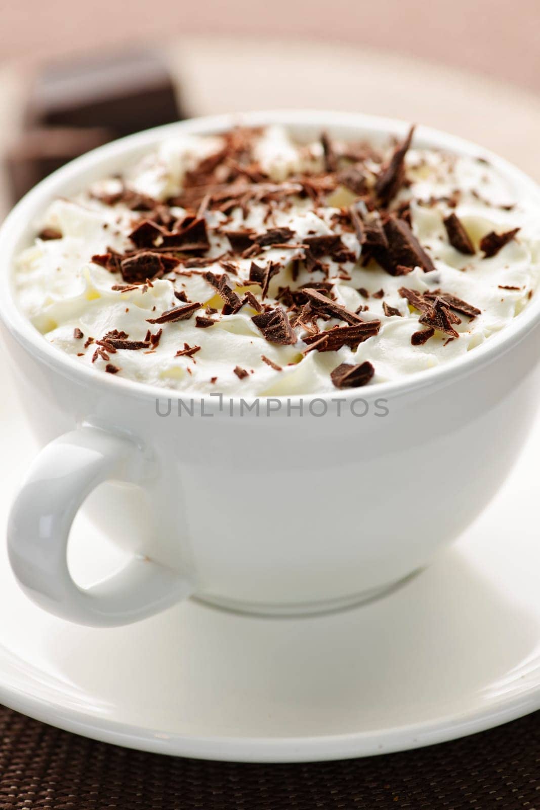 Cup of hot cocoa with shaved chocolate and whipped cream