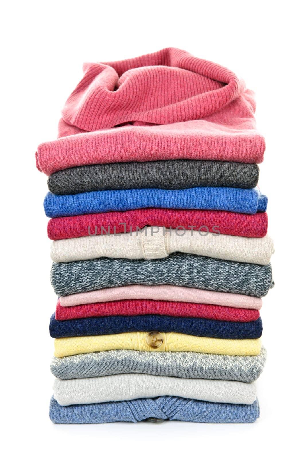 Stack of warm sweaters isolated on white background