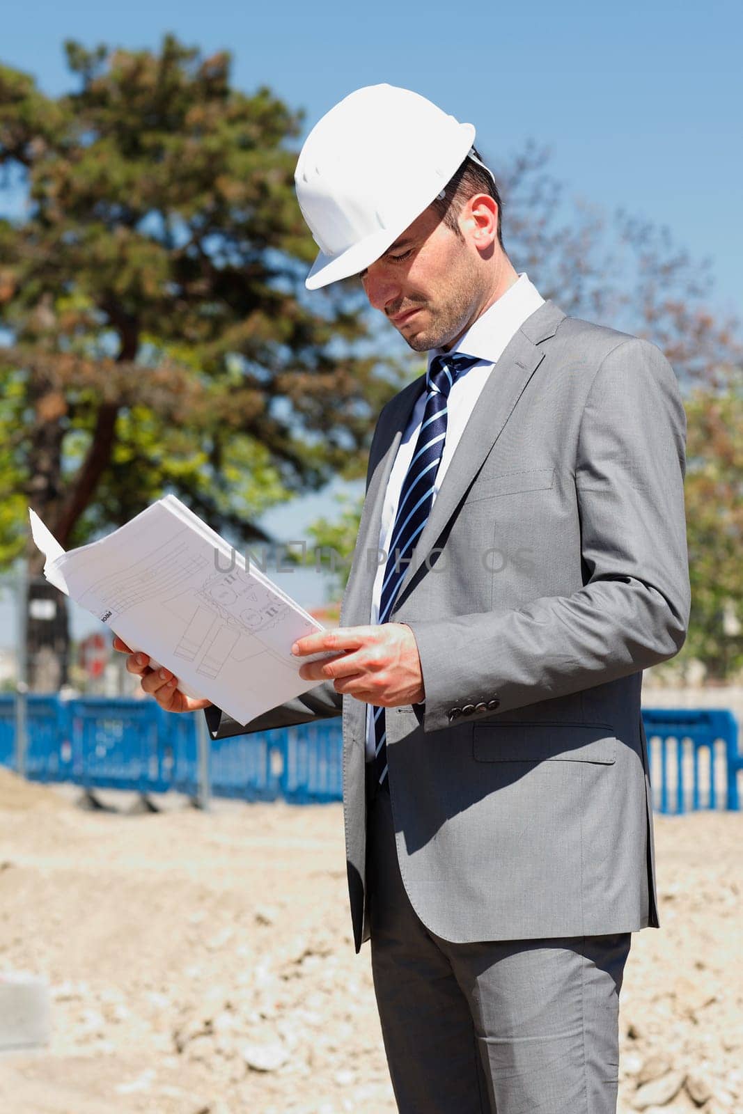 young architect on building site in summer
