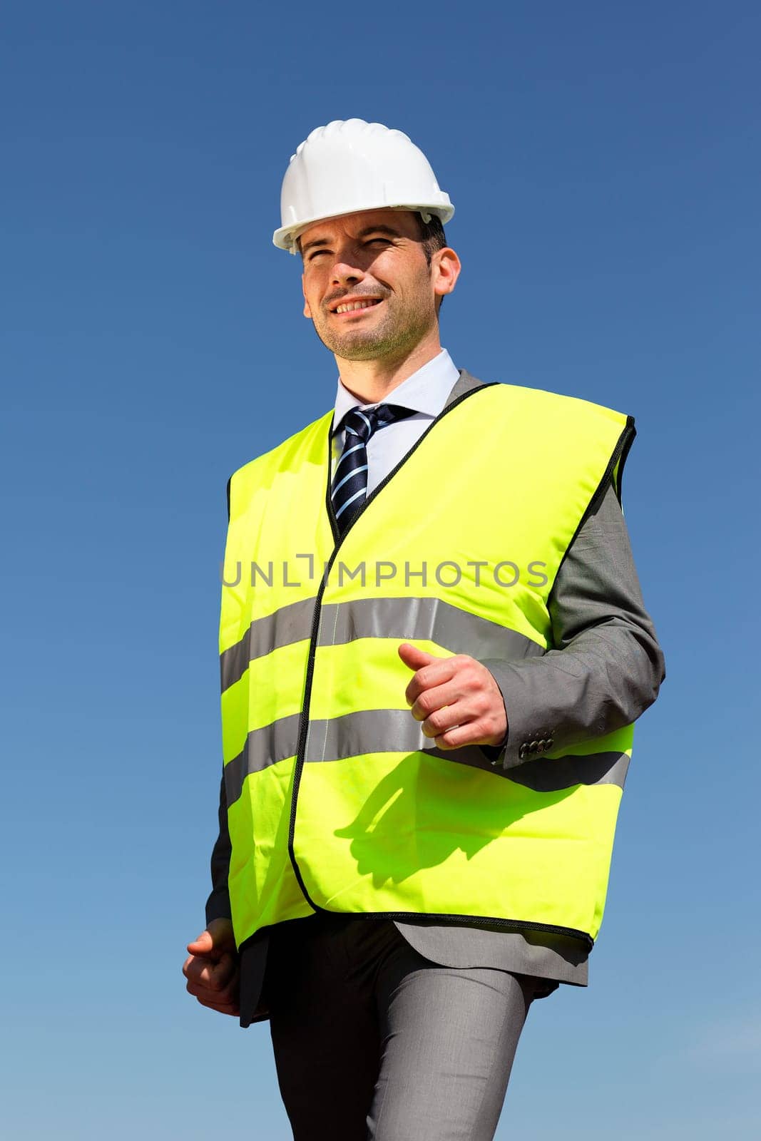 young businessman with hardhat and blue sky