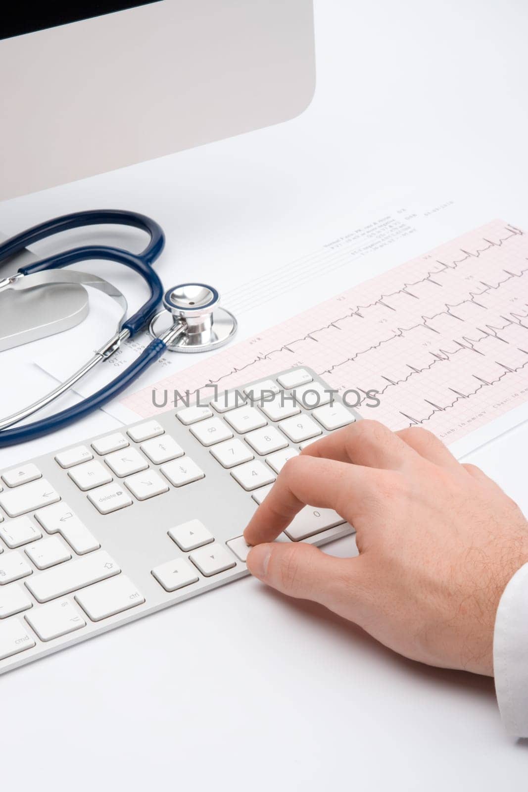 Doctor working with computer and electrocardiogram