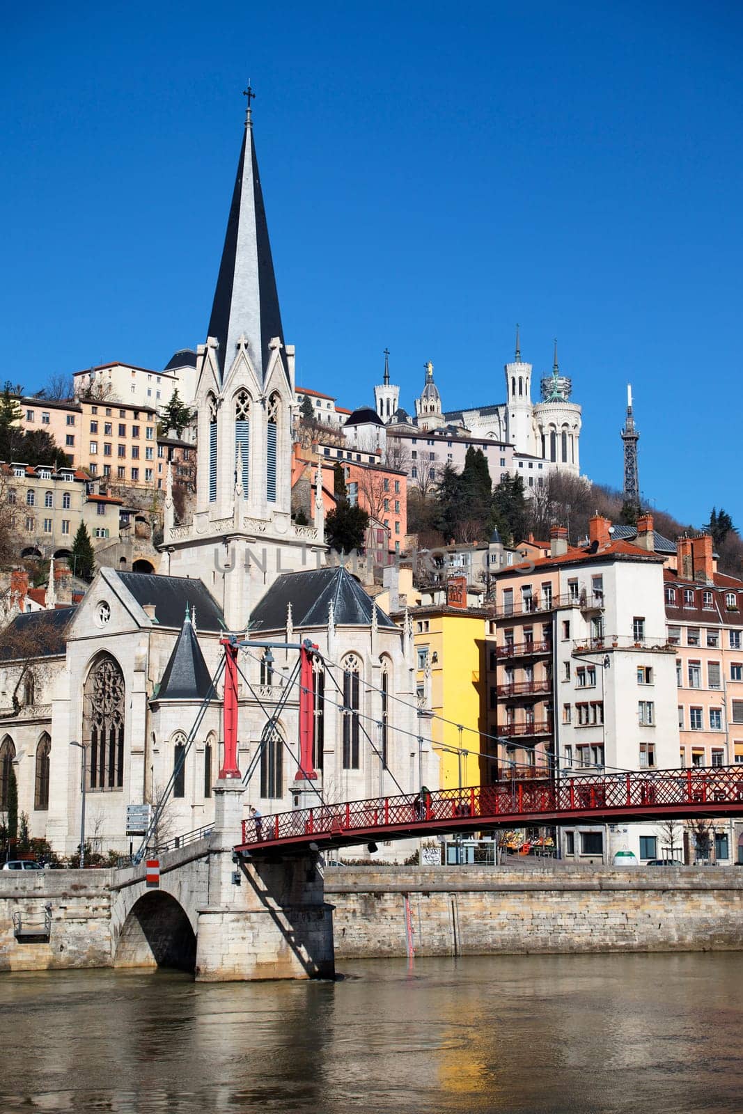 Lyon city with church and footbridge in blue sky
