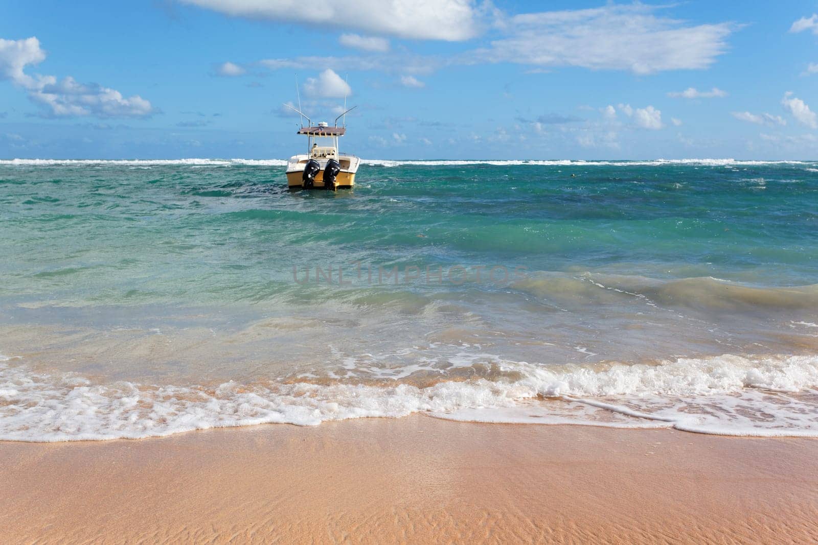 beach with boat on the sea and blue sky