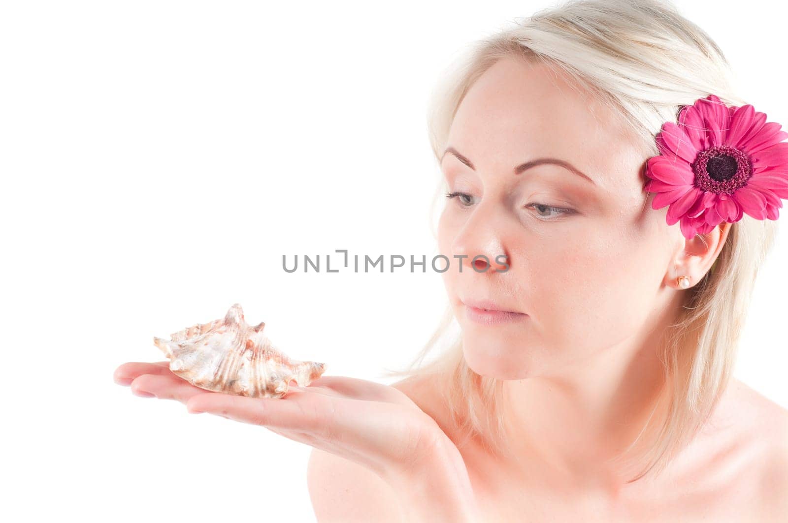 Shot of young woman holding shell on her palm