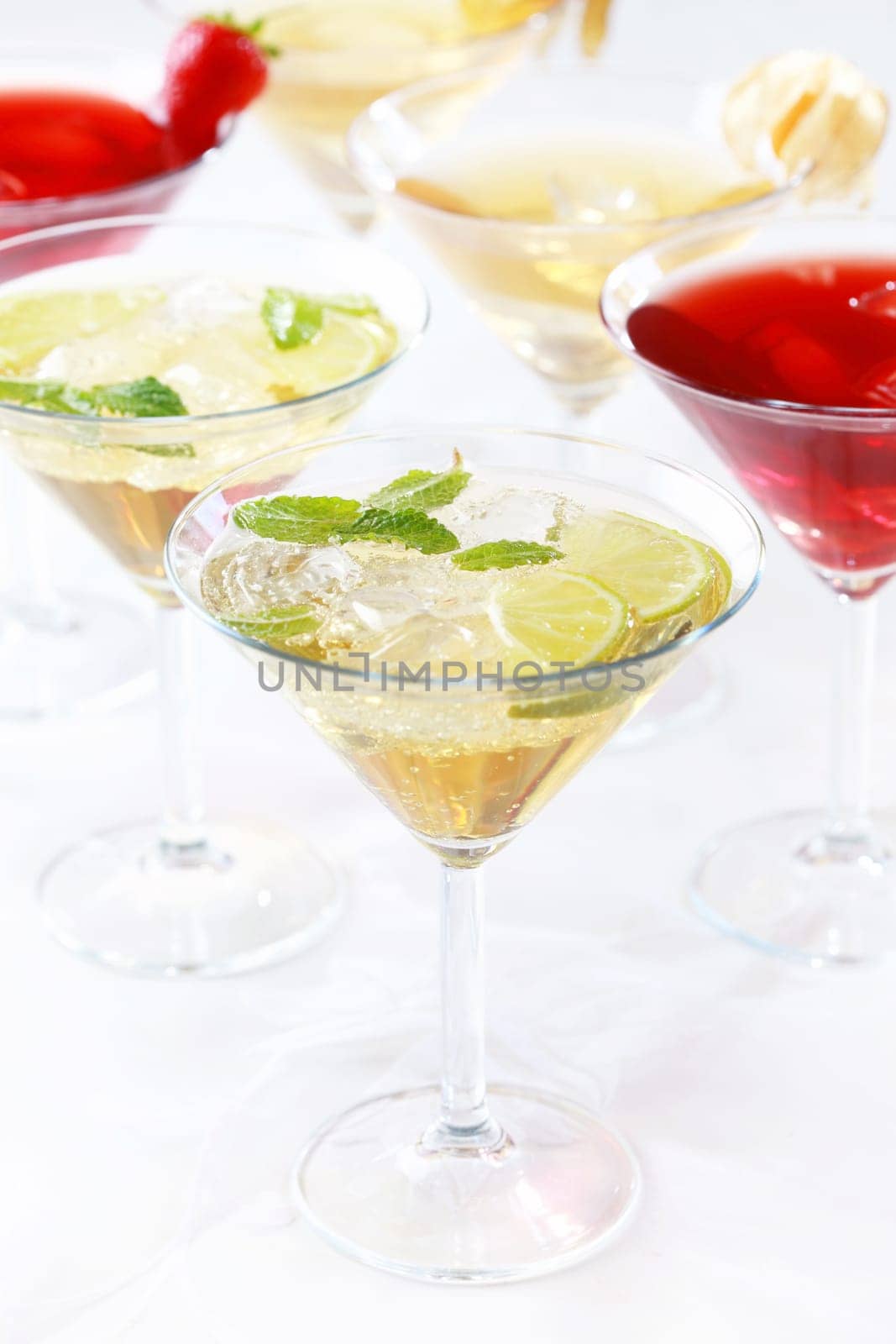 Different cocktails or longdrinks garnished with fruits