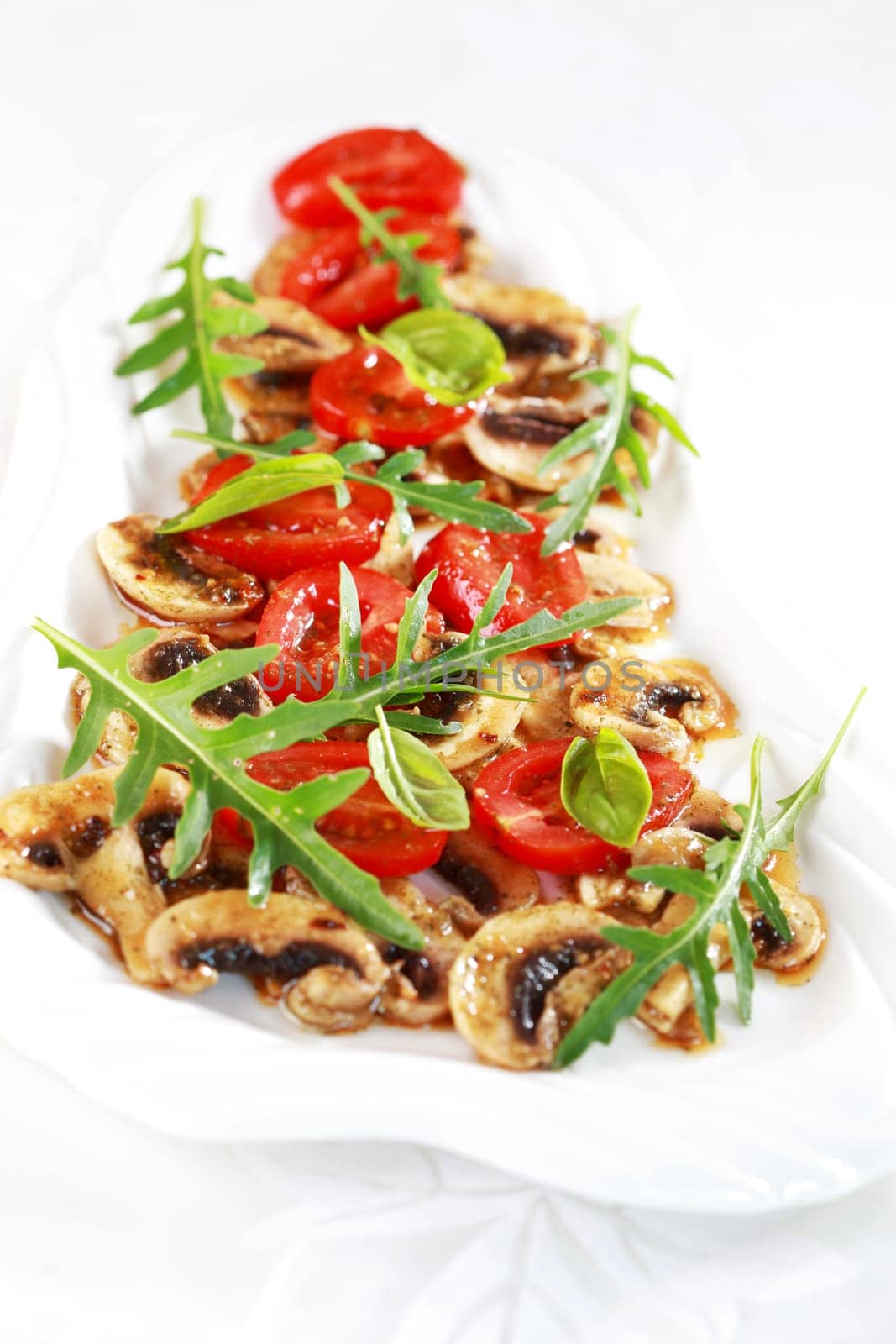 Champignon Carpaccio with marinated tomato and rucola salad