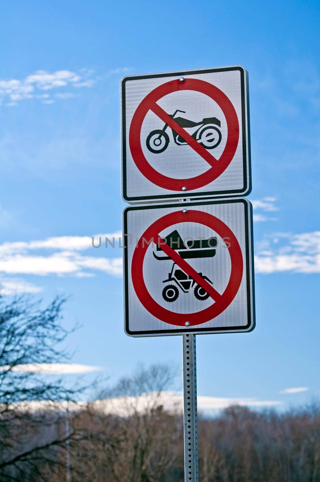 No motorcycles, no snowmobiles, no all-terrain vehicles, road sign.