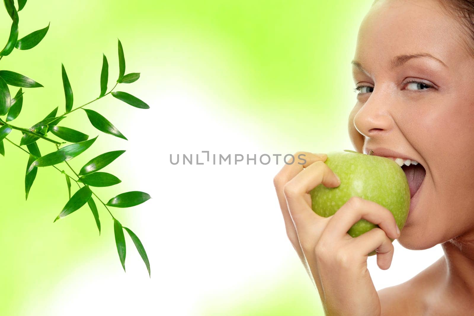 Caucasian beauty with green apple, against abstract green background