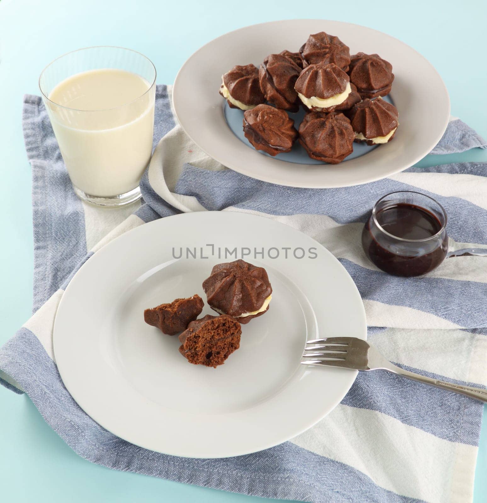 Delicious fresh baked chocolate star biscuits with chocolate sauce and a glass of milk.