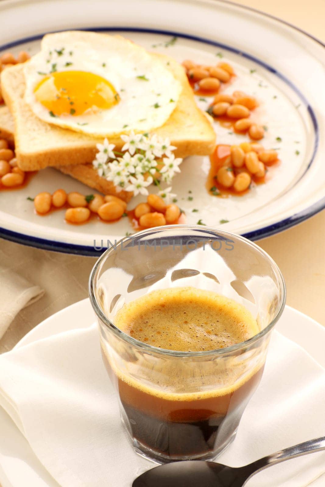 Fried egg with beans with a strong short black coffee.