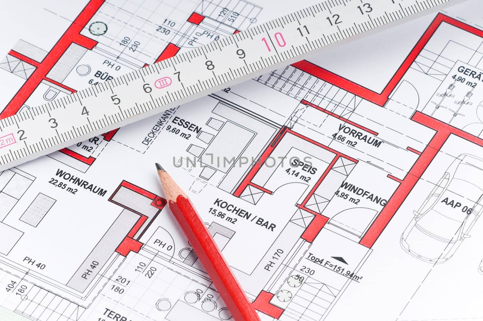 Red pencil with ruler on a house plan