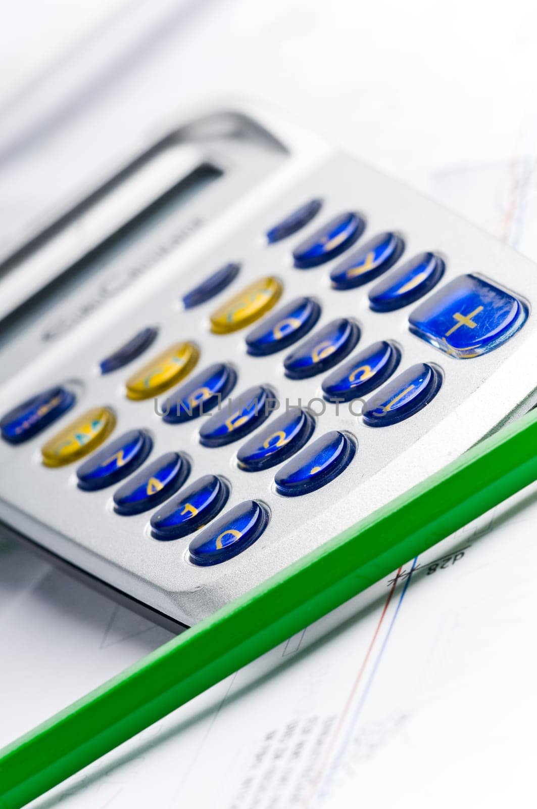 Detail of an industrial plan with green pencil and calculator
