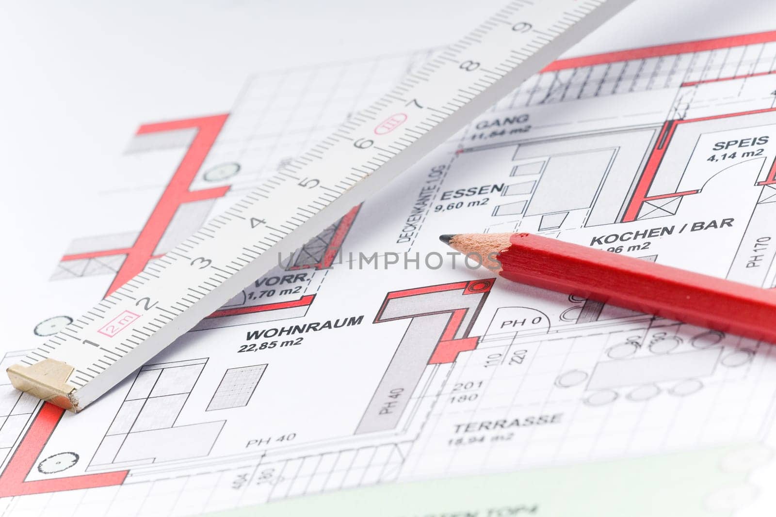 Red pencil with ruler on a house plan