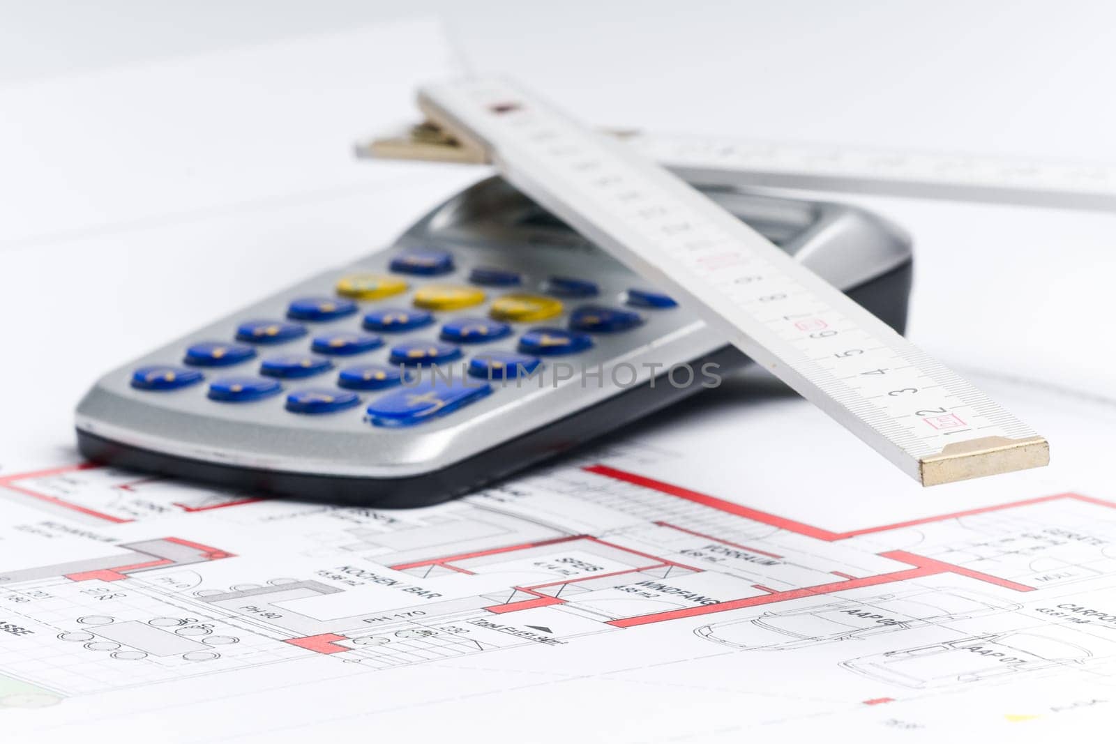 Calculator and ruler on a house plan for calculation