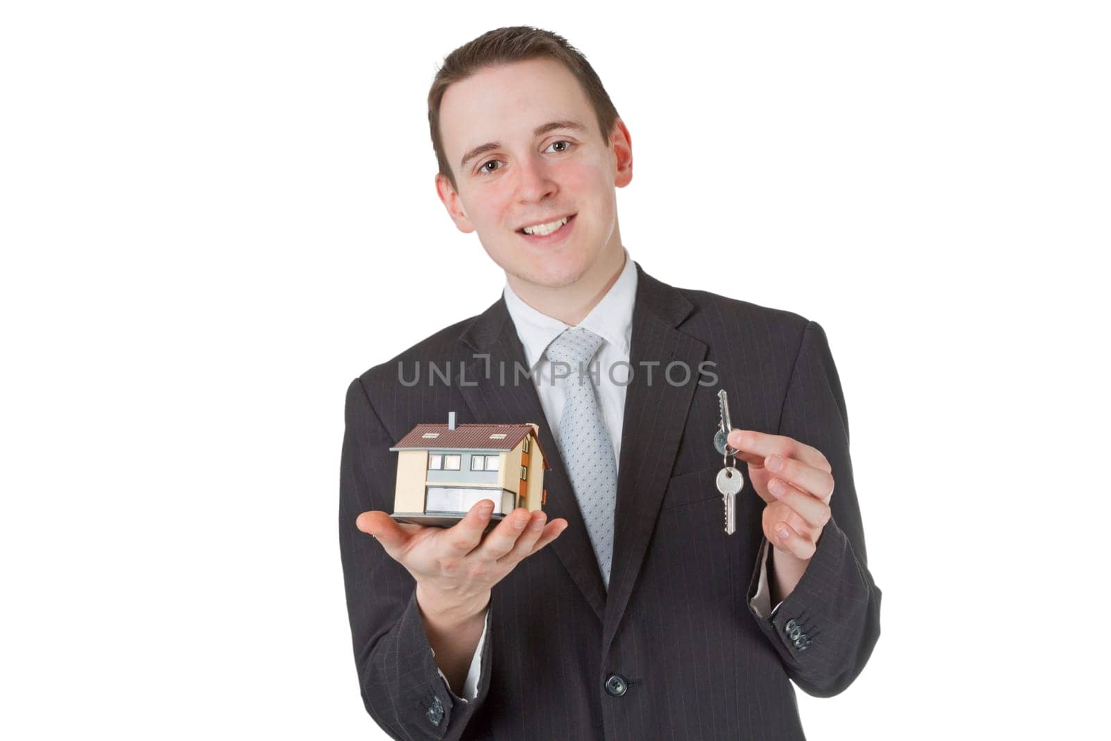 Friendly businessman presenting model house - isolated on white background