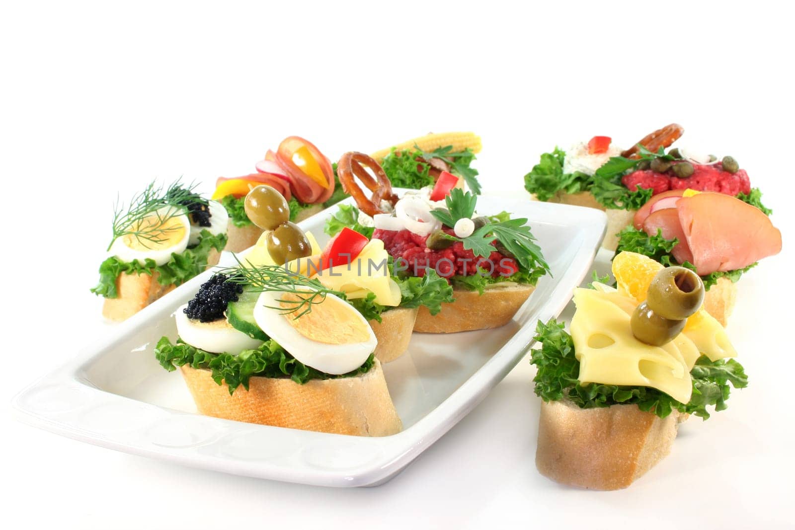 Various canapes against white background