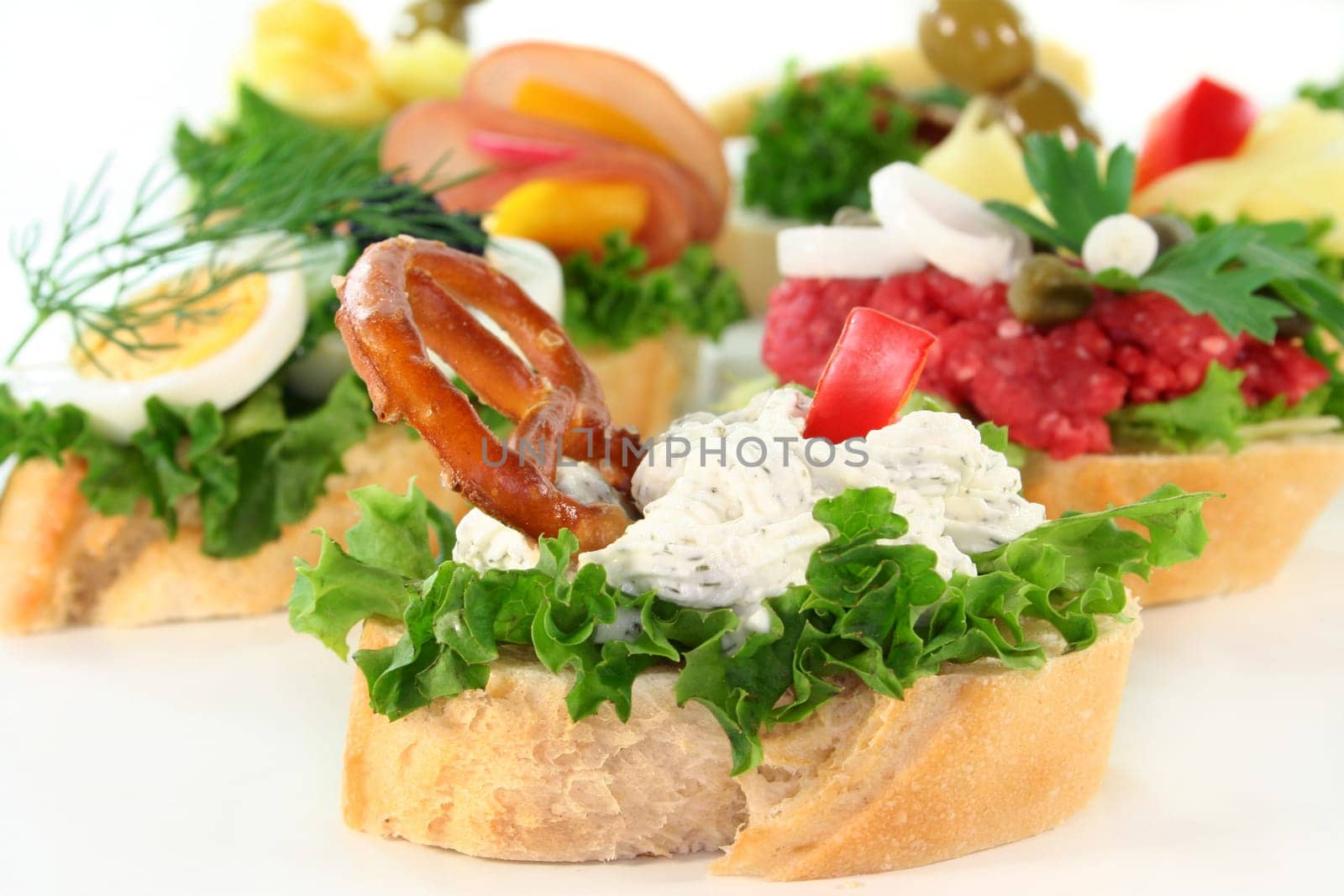 Various canapes against white background
