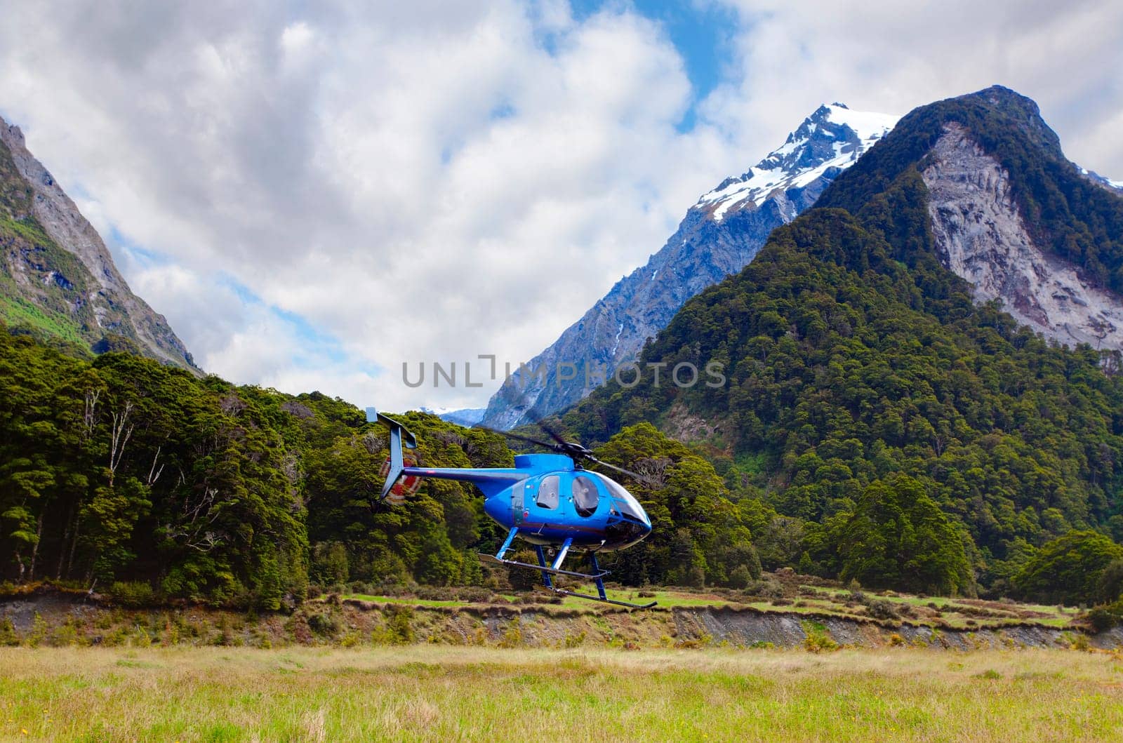 Helicopter taking off in the Wilkin river valley of New Zealand