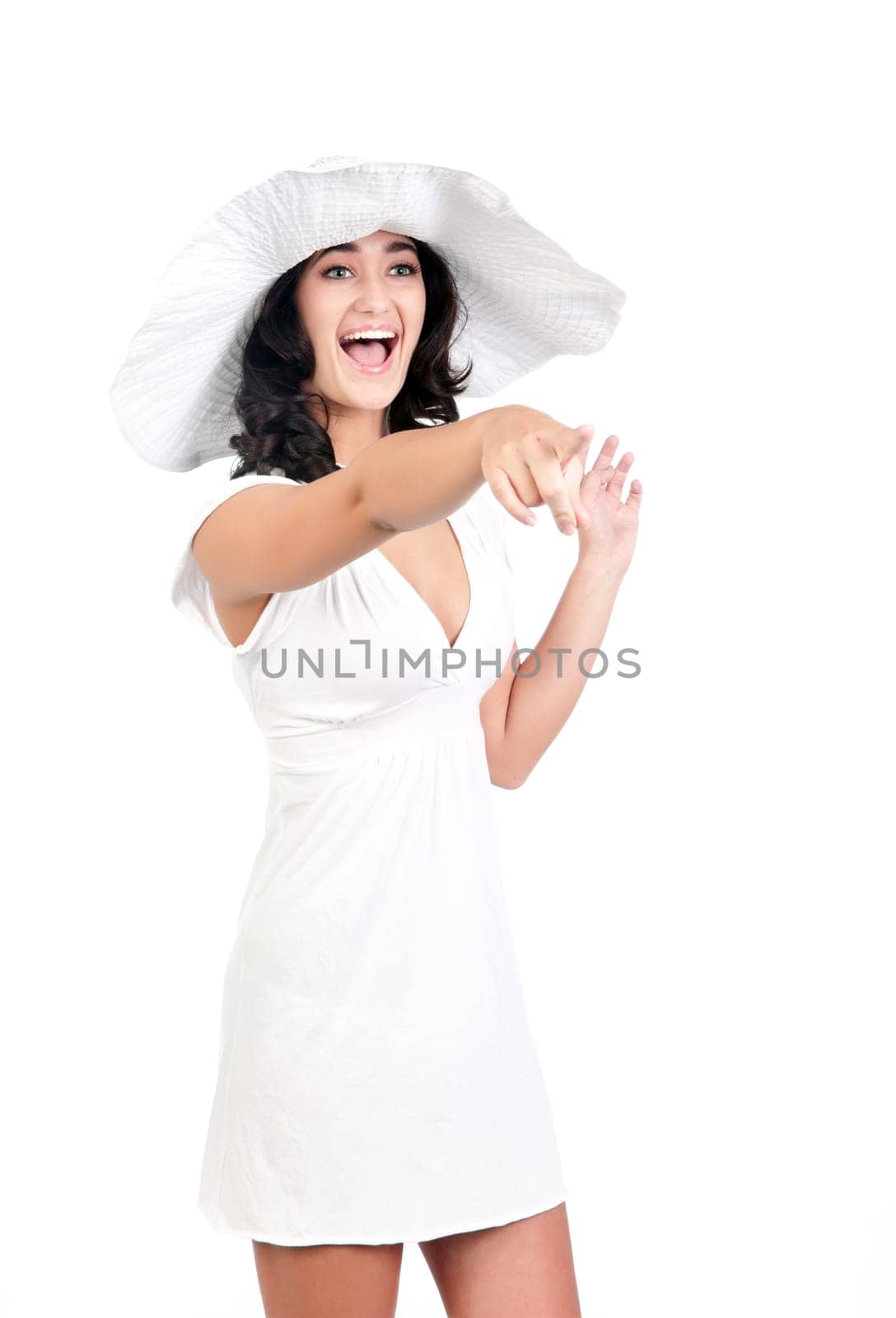 beautiful young fashion woman in white dress and hat points