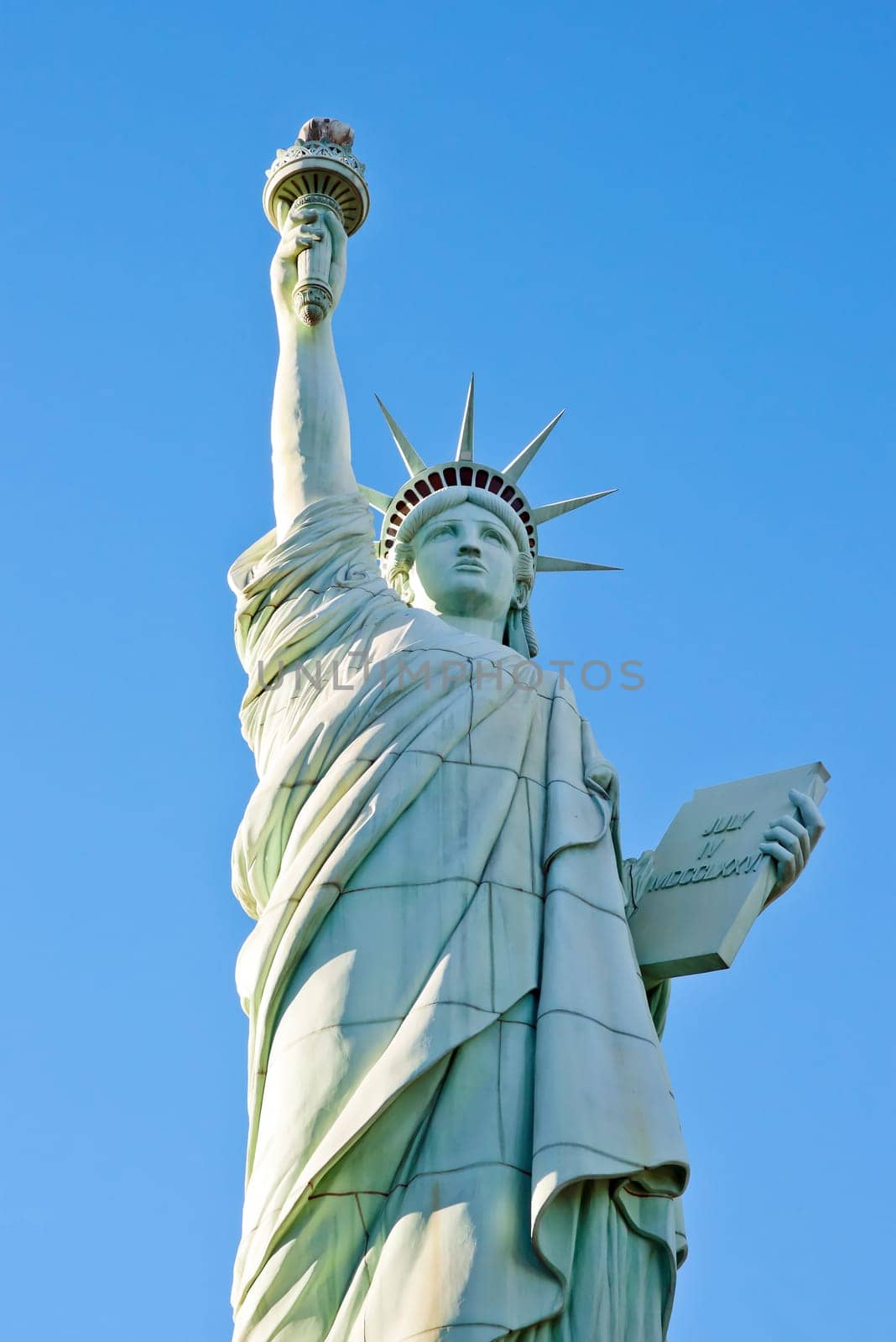 statue of liberty in front of clear blue sky