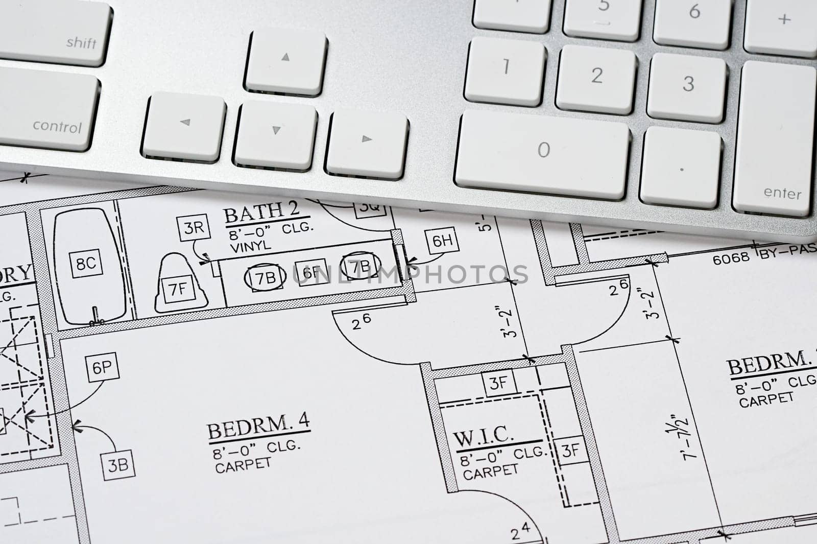 Modern arcbhitect&#039 s offic with blueprint and computer keyboard