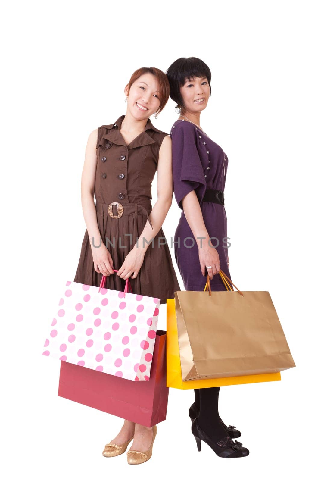 Happy shopping women holding bags, full length portrait isolated on white background.