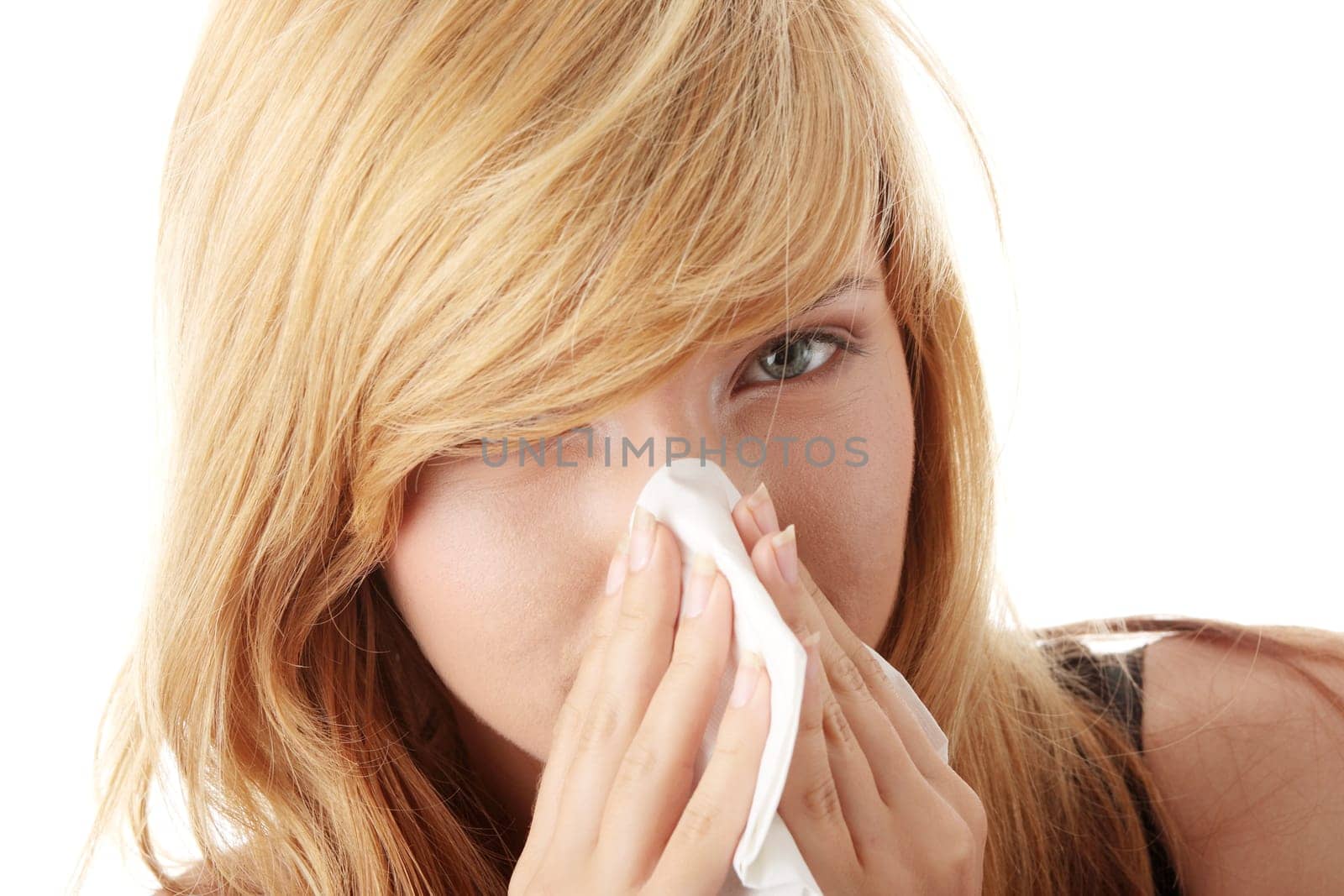 Young blonde woman having a cold close up isolated on white background