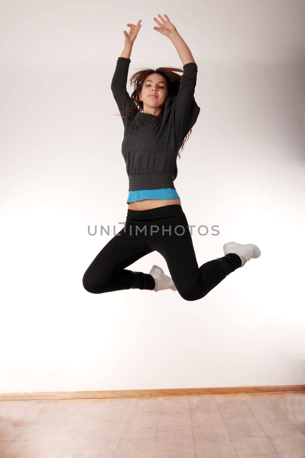 Young stylish woman training modern dance