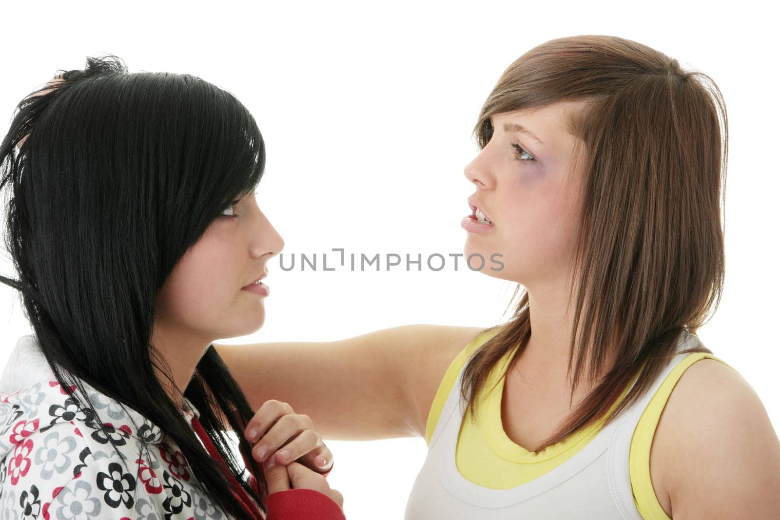 Two young teens (sisters) fighting - isolated on white