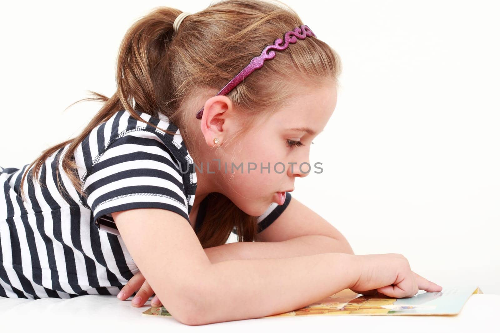 Cute little girl reading a book