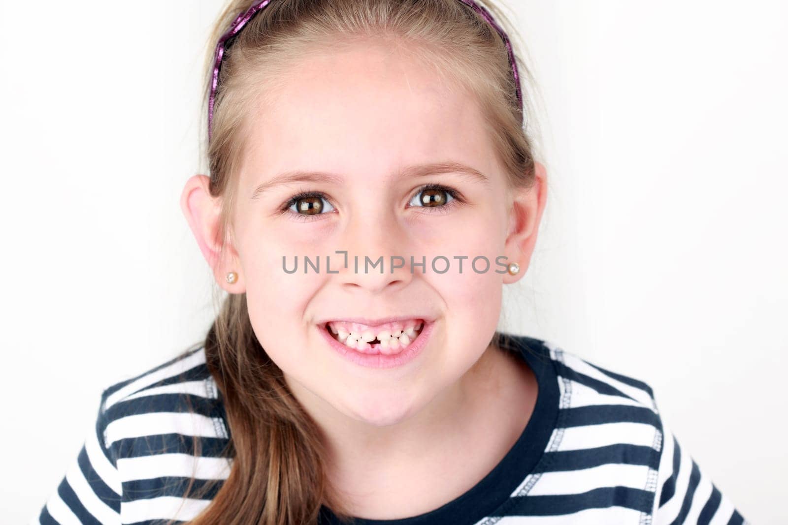Happy girl with her first missing tooth