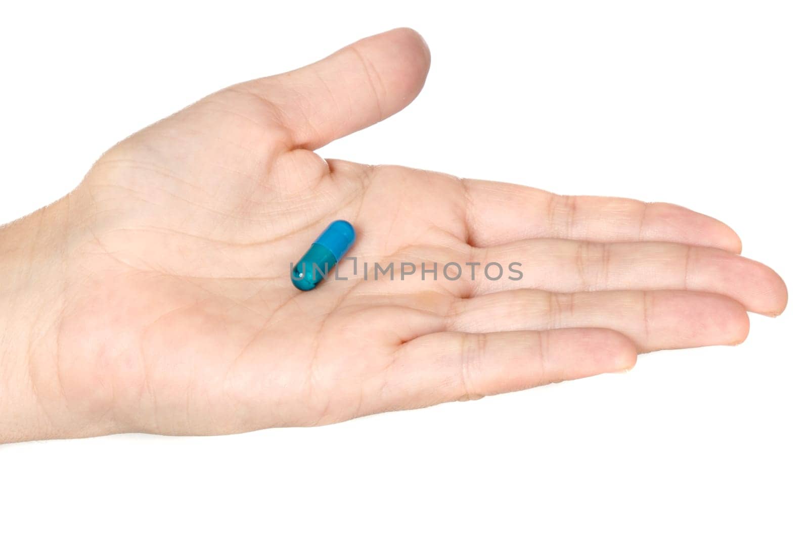 Photo of a hand with a pill over a white background