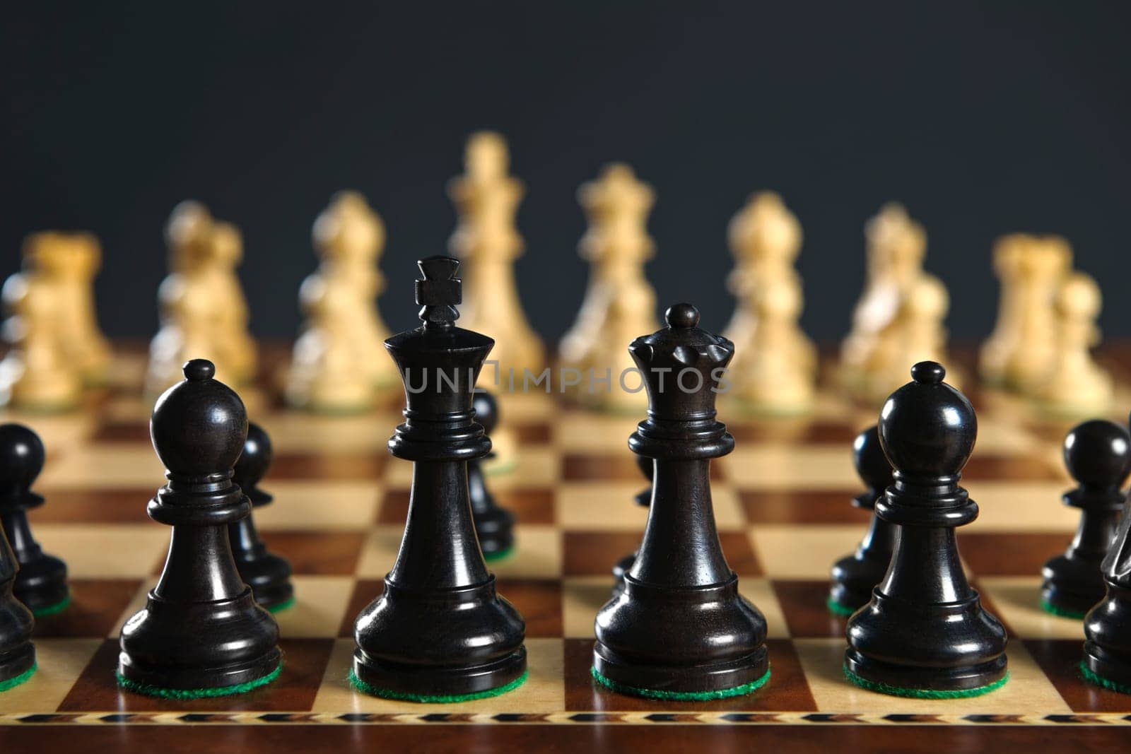 Close up of chess pieces on wooden chessboard
