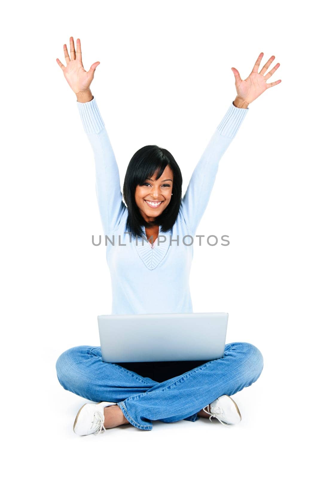 Happy black woman with arms raised and computer isolated on white background