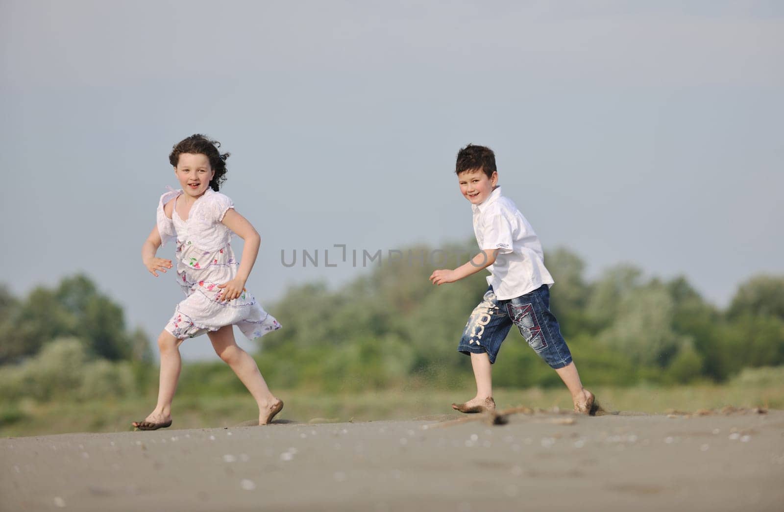 happy young family have fun and live healthy lifestyle on beach