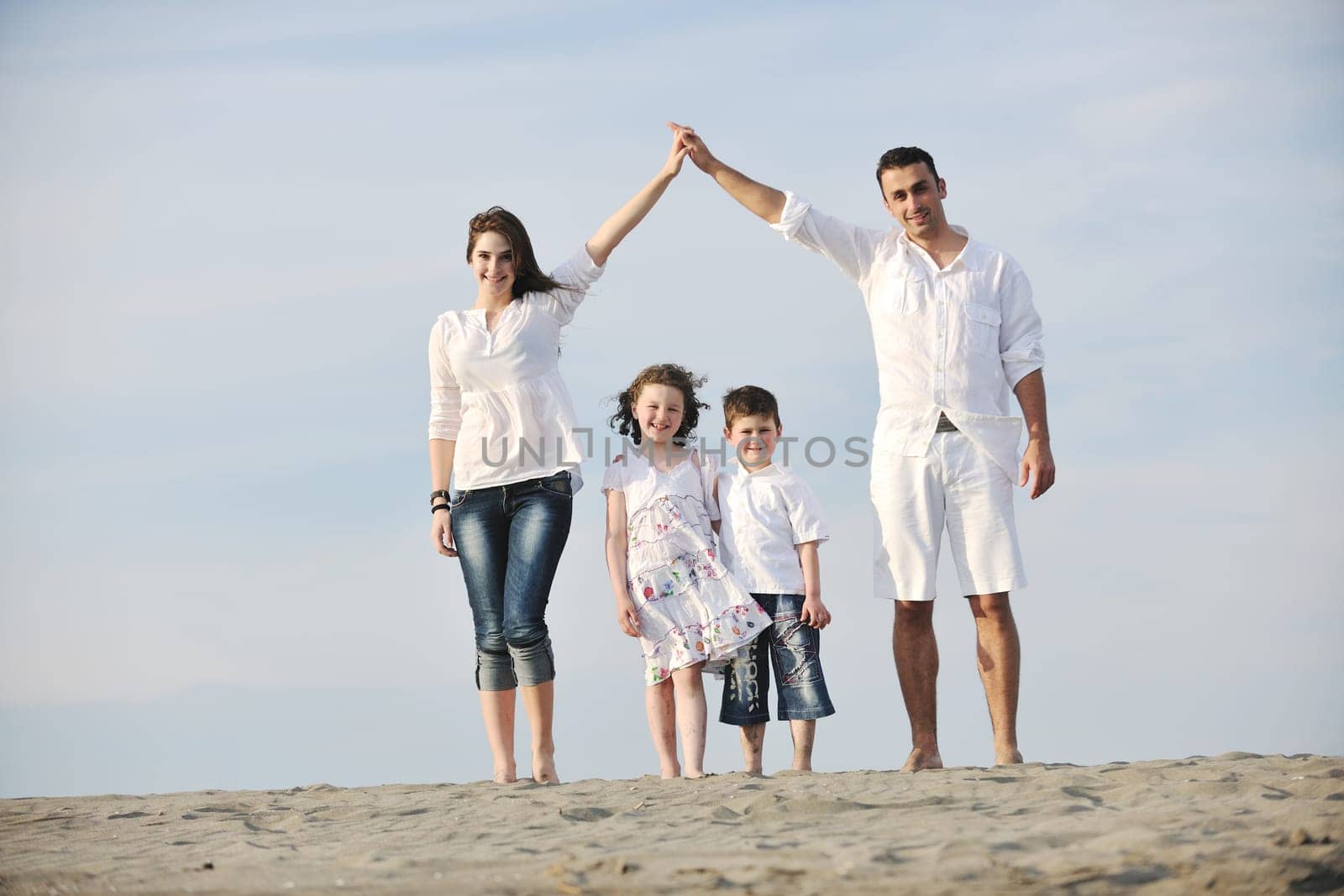 happy young family have fun and live healthy lifestyle on beach
