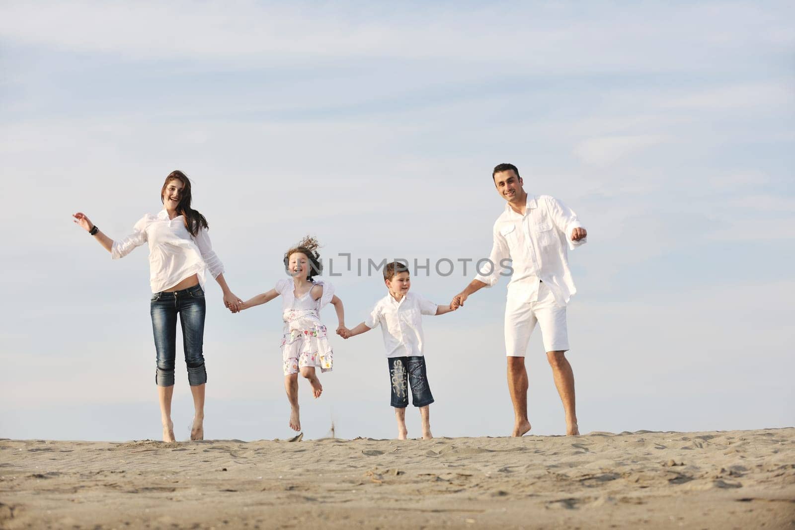happy young family have fun and live healthy lifestyle on beach