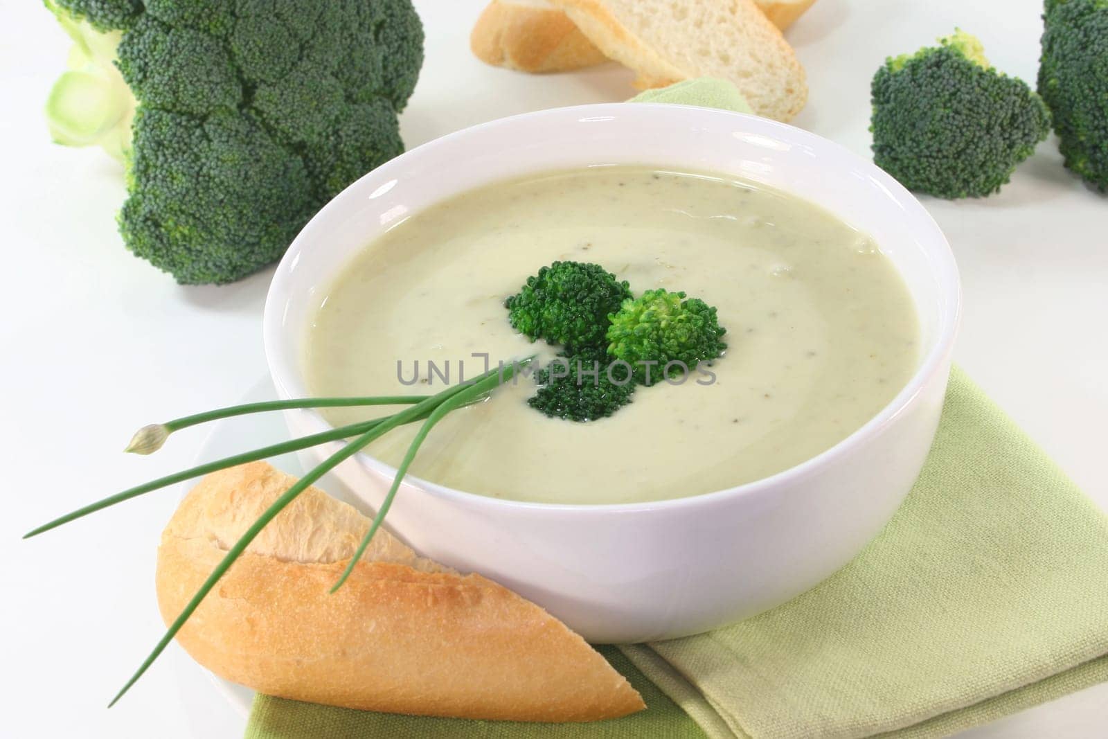 a bowl of broccoli cream soup with fresh vegetables