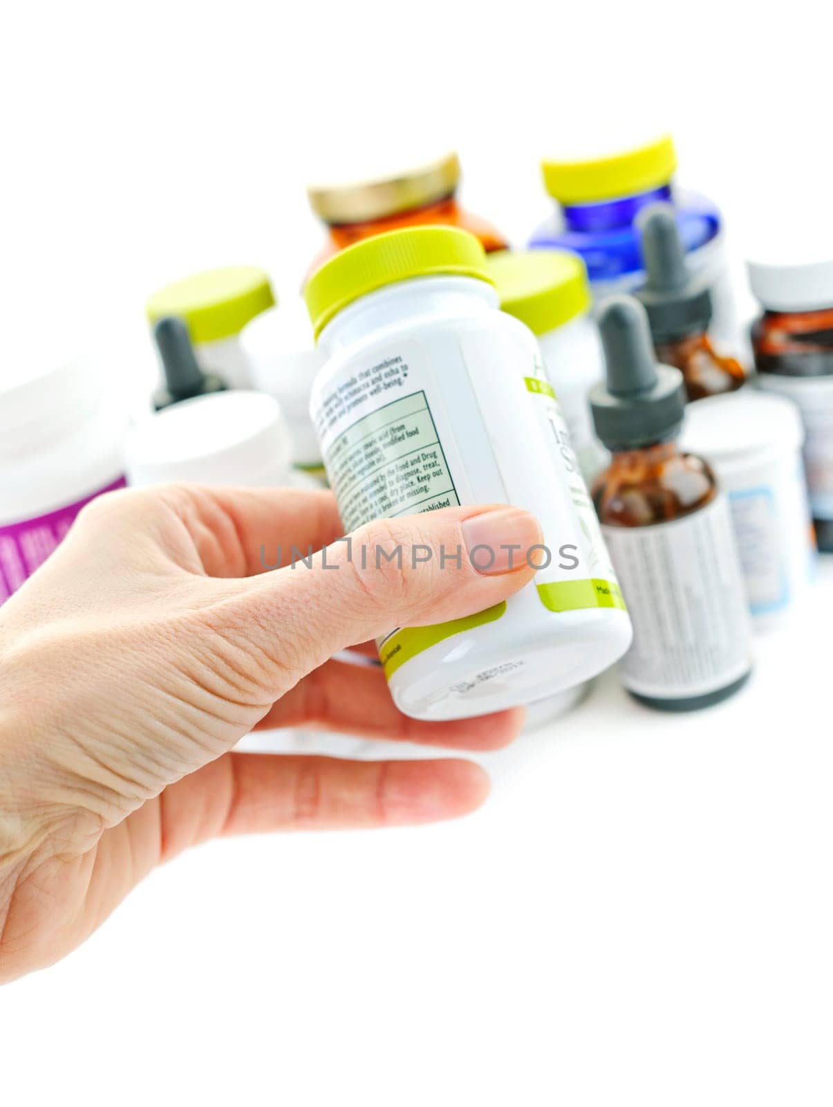 Hand holding medicine bottle to read label